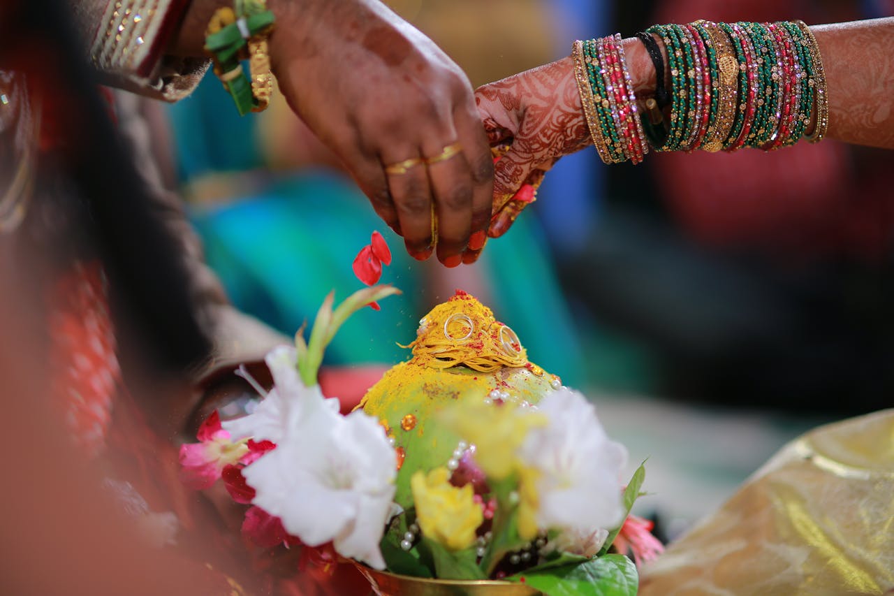 Colorful Indian wedding rituals with traditional attire and floral decorations.