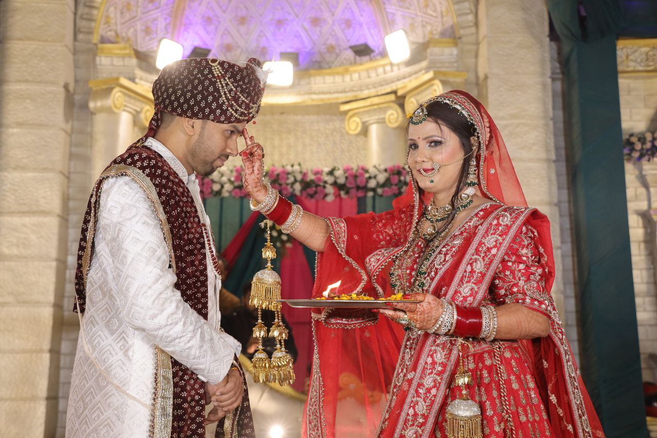 Bride and groom performing a traditional ritual at an Indian wedding.
