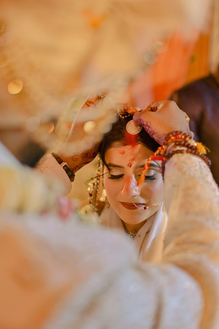 Close-up of a groom performing a traditional ritual in an Indian wedding ceremony.
